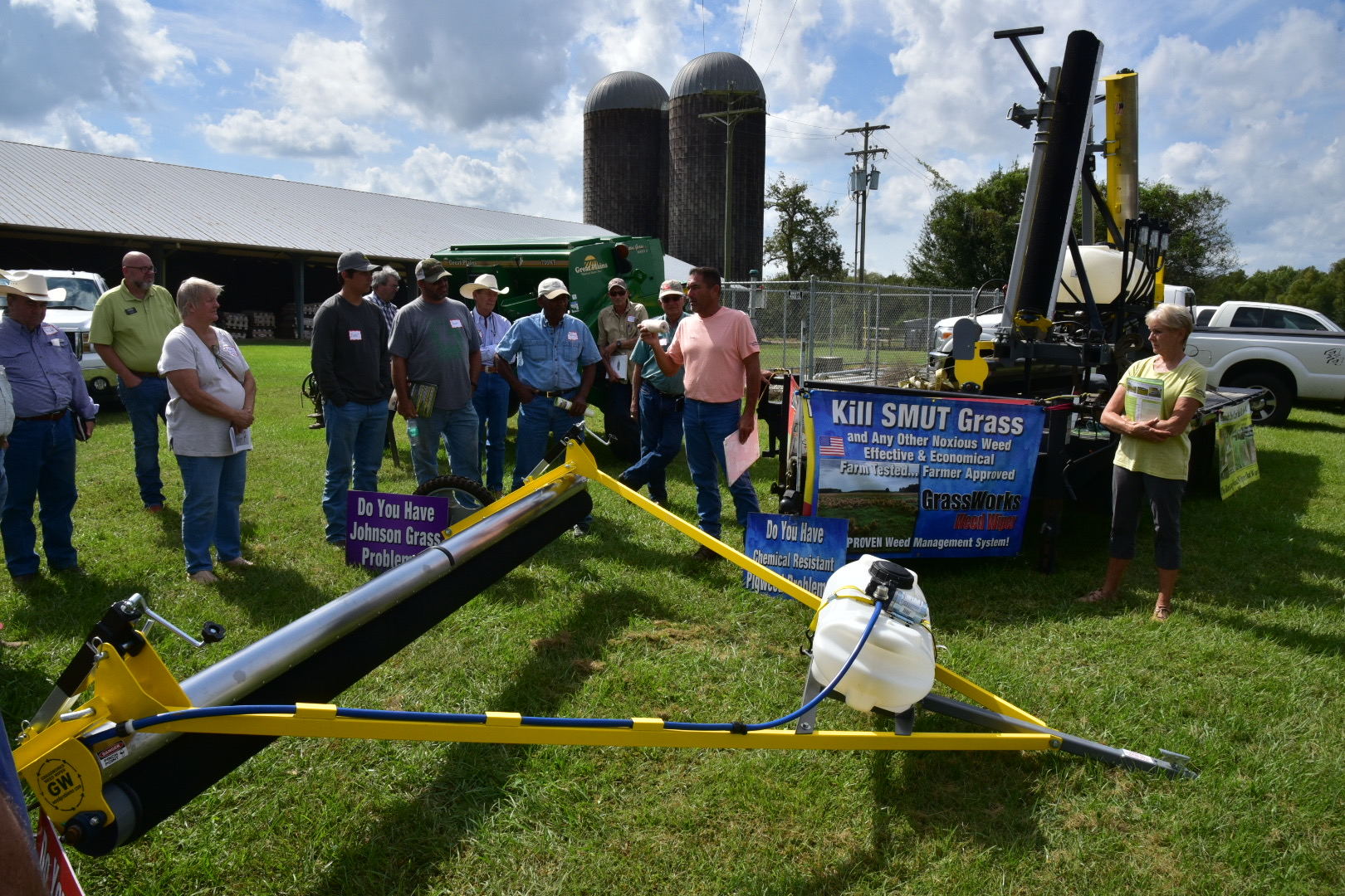People watching an equipment demonstration at the field day.